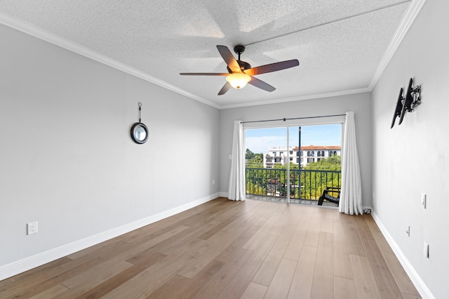 empty room with ceiling fan, crown molding, and a textured ceiling