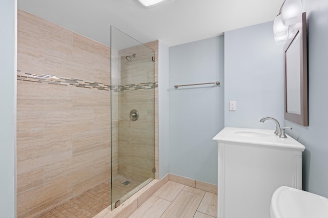 bathroom with tile patterned flooring, vanity, and a shower with door