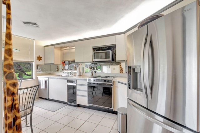 kitchen with appliances with stainless steel finishes and light tile patterned floors