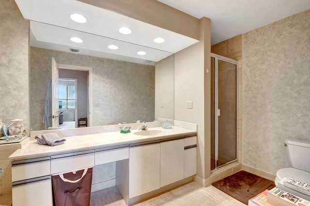 bathroom featuring vanity, hardwood / wood-style floors, toilet, and walk in shower