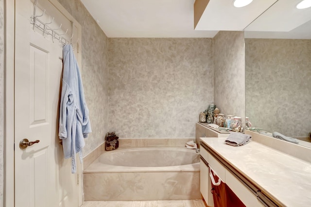 bathroom with vanity and a bath