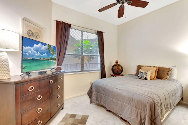 bedroom with light carpet and ceiling fan