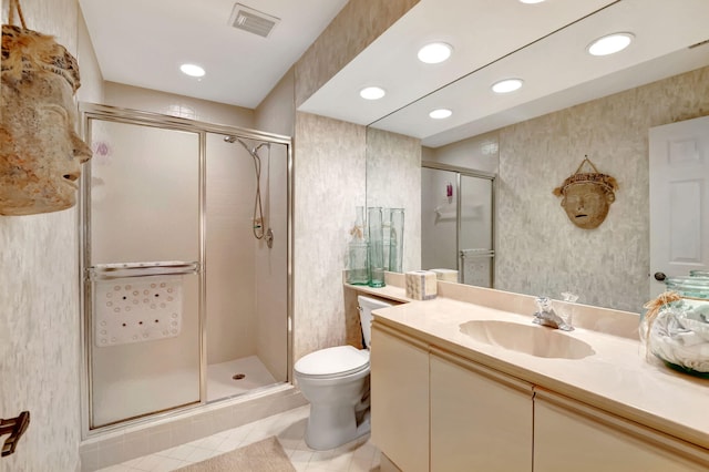 bathroom featuring vanity, an enclosed shower, toilet, and tile patterned flooring