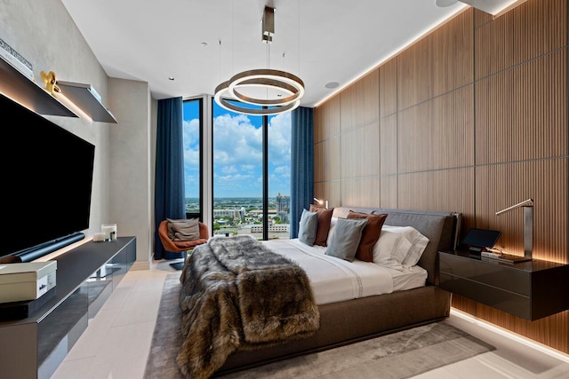 bedroom with a wall of windows and wooden walls