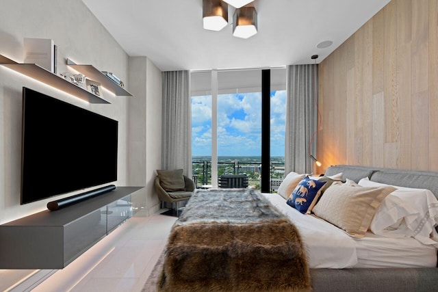 bedroom featuring expansive windows, access to exterior, and wood walls