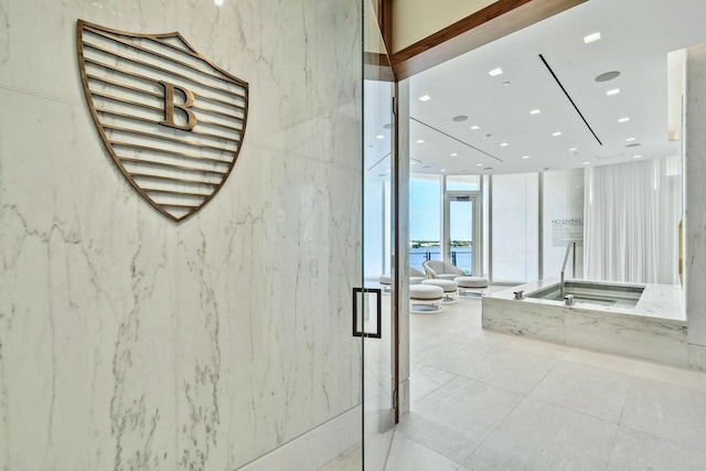 bathroom featuring a bidet, floor to ceiling windows, and a water view