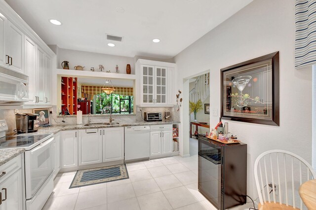 6366 Longboat Ln Unit G104, Boca Raton, FL 33433 - kitchen featuring white appliances, a sink, white cabinetry, glass insert cabinets, and backsplash