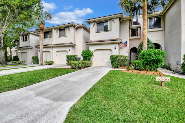 view of front of home featuring a front yard and a garage