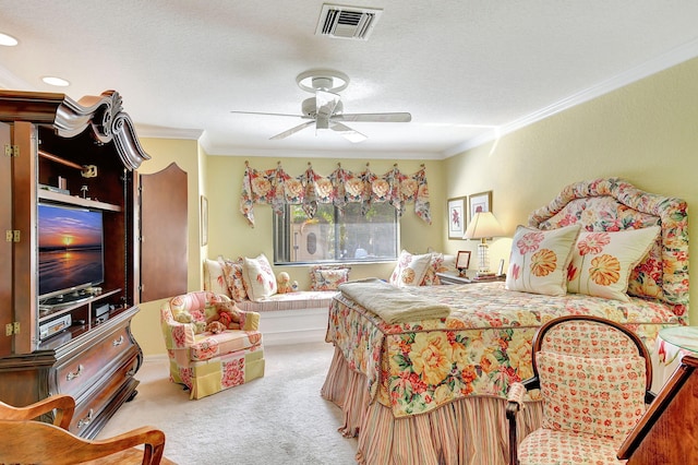 bedroom with ornamental molding, a textured ceiling, carpet floors, and ceiling fan