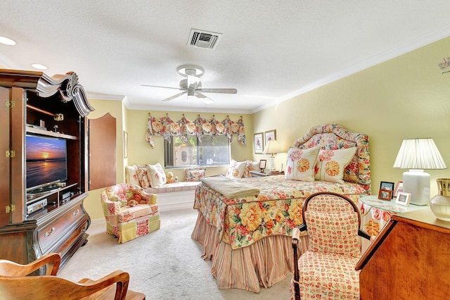 bedroom with a textured ceiling, ornamental molding, light colored carpet, and ceiling fan