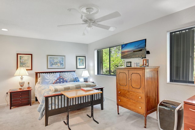 bedroom with ceiling fan and light colored carpet