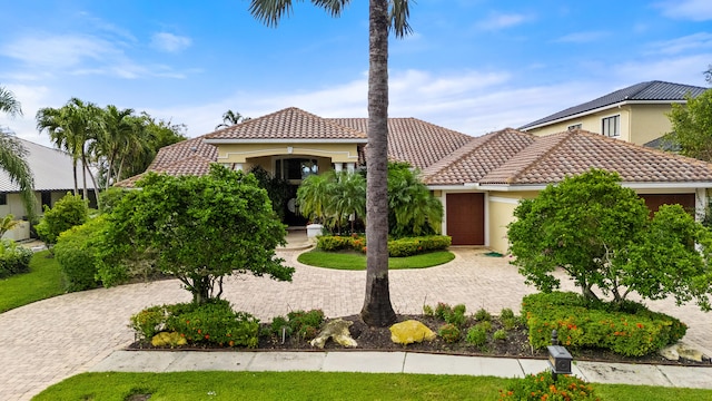 mediterranean / spanish-style home with a garage