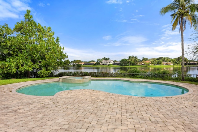 view of swimming pool with a patio area, an in ground hot tub, and a water view