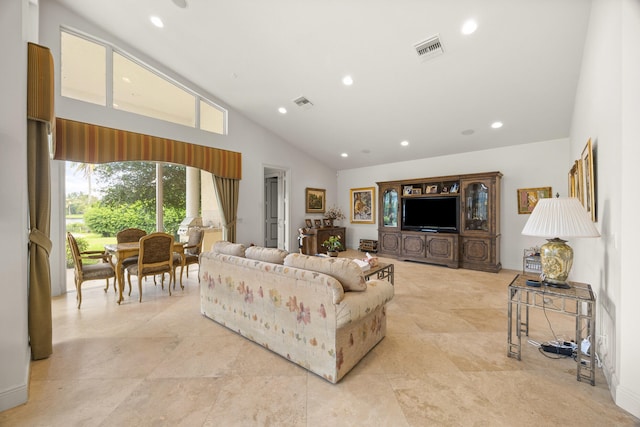 living room with high vaulted ceiling