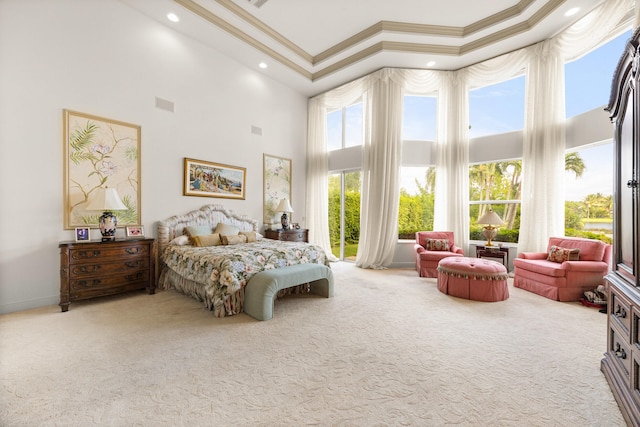 carpeted bedroom featuring crown molding, multiple windows, and a towering ceiling