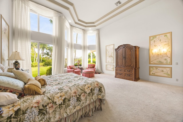 carpeted bedroom featuring a towering ceiling, crown molding, access to exterior, and a tray ceiling