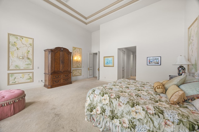 bedroom featuring a high ceiling and light carpet