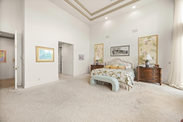 carpeted bedroom with a high ceiling