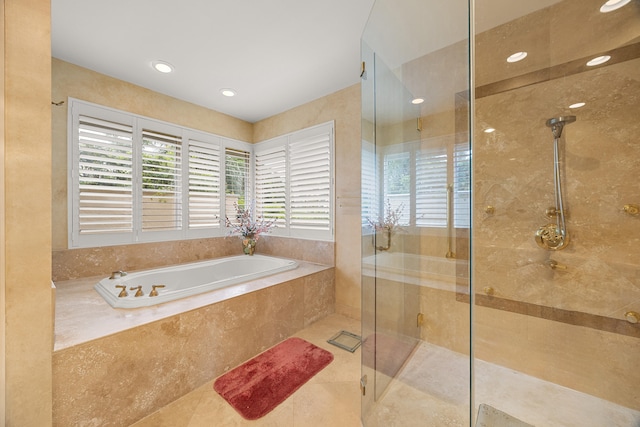 bathroom with tile patterned floors and separate shower and tub