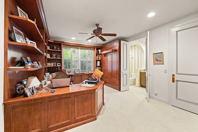 carpeted office space with ceiling fan