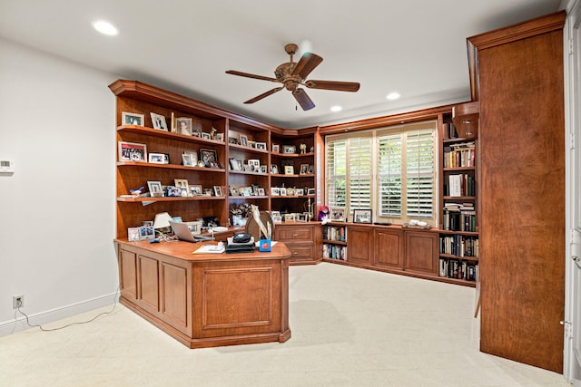 carpeted home office featuring ceiling fan