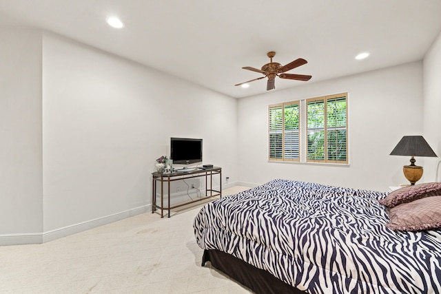 bedroom featuring light colored carpet and ceiling fan