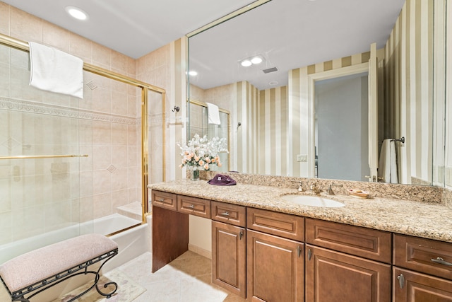 bathroom featuring vanity, shower / bath combination with glass door, and tile patterned flooring