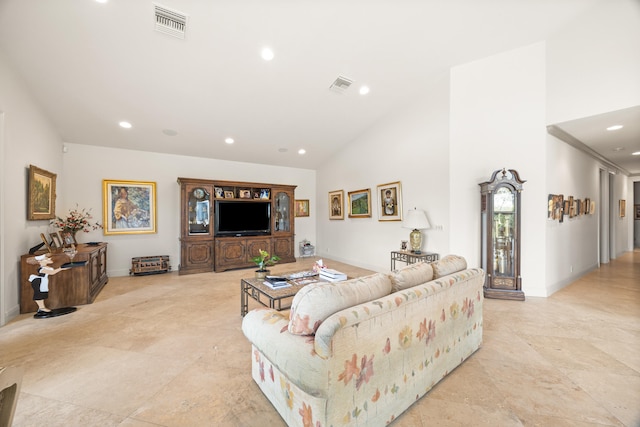 living room with high vaulted ceiling