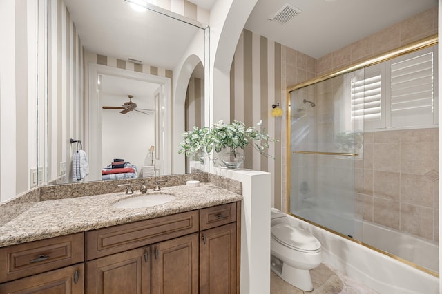 full bathroom with toilet, tile patterned flooring, vanity, enclosed tub / shower combo, and ceiling fan