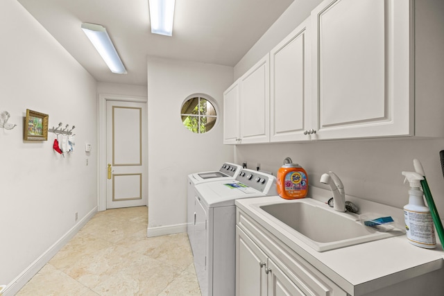 laundry room with sink, cabinets, and separate washer and dryer