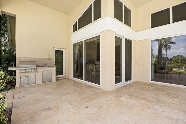 view of patio with an outdoor kitchen and area for grilling