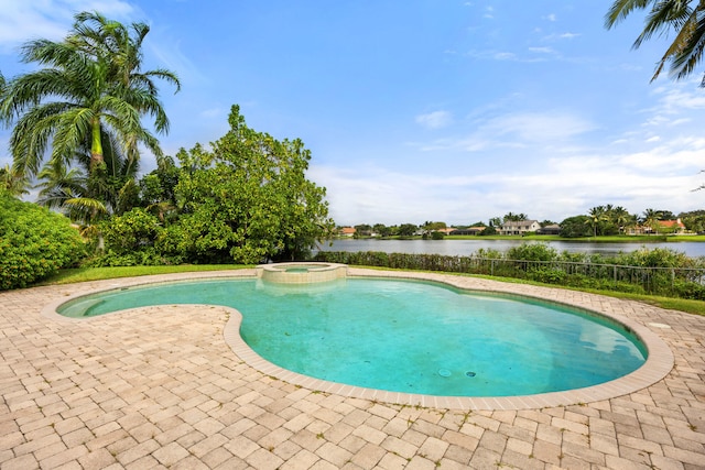 view of swimming pool with a patio area, an in ground hot tub, and a water view