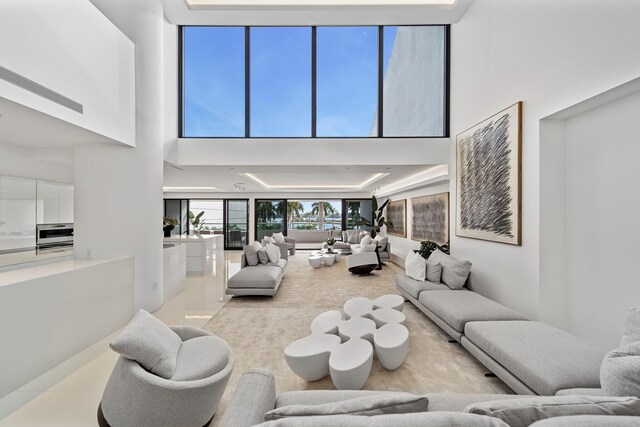 tiled living room featuring a high ceiling