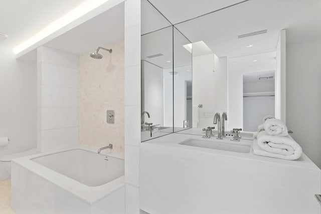 bathroom with tiled shower / bath and sink