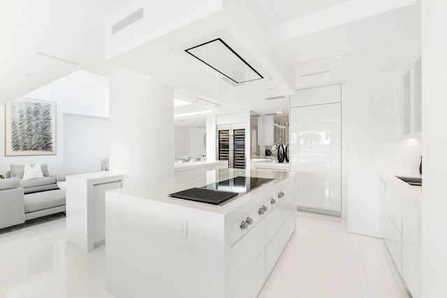 kitchen featuring white cabinetry, a center island, and light tile patterned floors