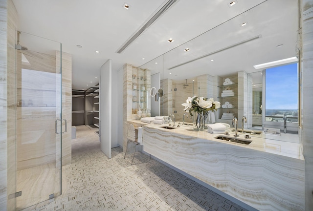 bathroom with a shower with door and vanity