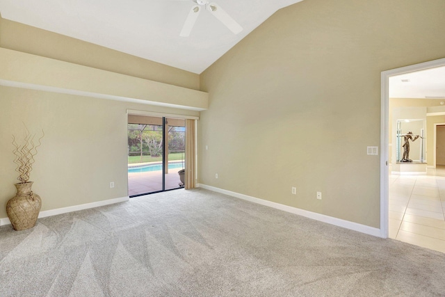 carpeted spare room featuring ceiling fan and vaulted ceiling