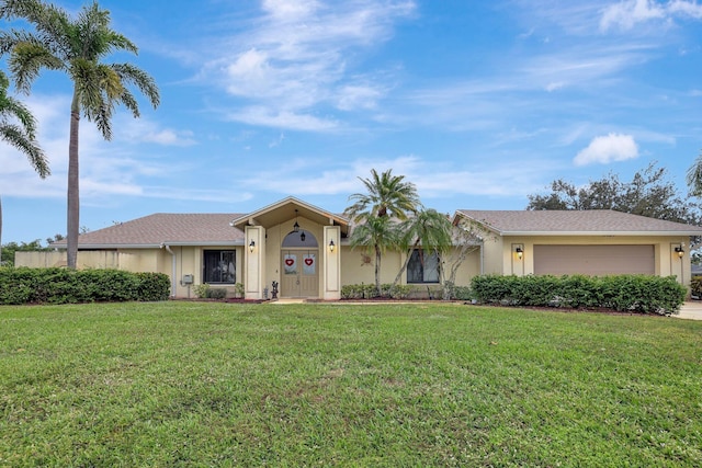 ranch-style house featuring a garage and a front lawn