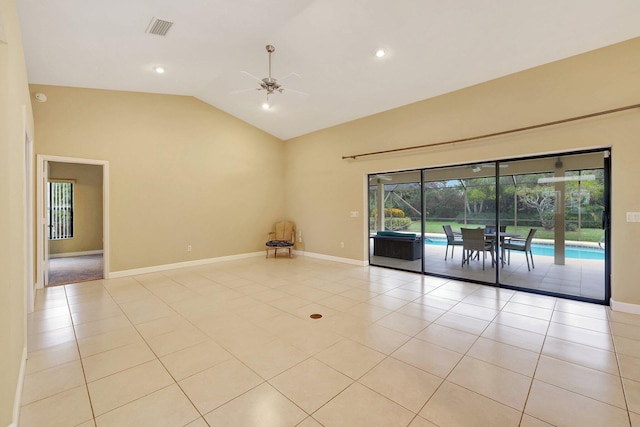 tiled empty room with high vaulted ceiling and ceiling fan