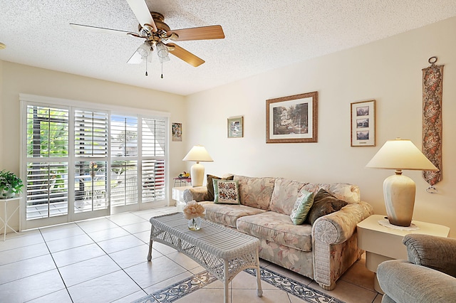 tiled living room featuring ceiling fan and a textured ceiling