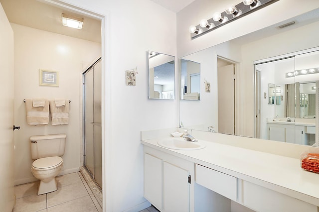 bathroom with walk in shower, tile patterned floors, toilet, and vanity