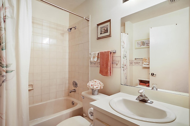 full bathroom with vanity, shower / bath combo, and toilet