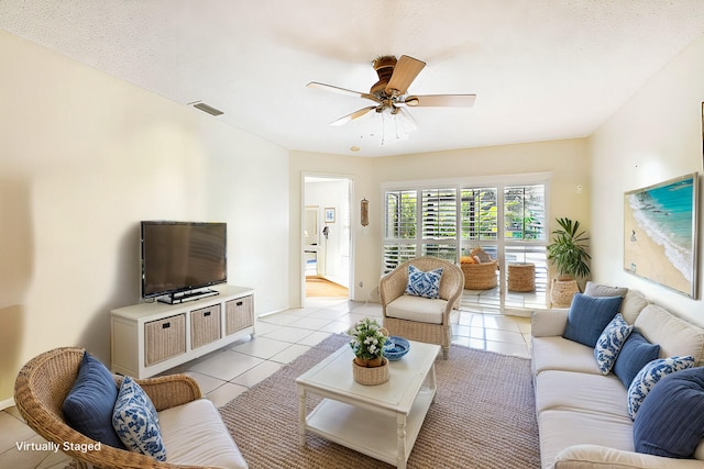 tiled living room with ceiling fan