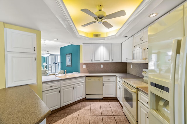 kitchen with kitchen peninsula, white cabinetry, ornamental molding, sink, and white appliances