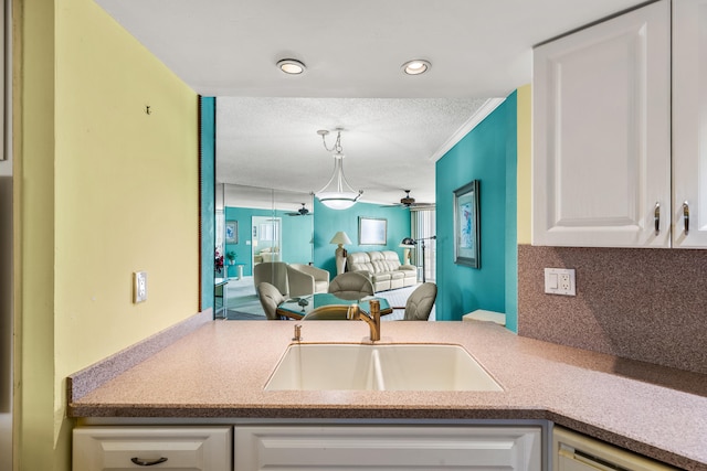 9500 S Ocean Dr Unit 1909, Jensen Beach, FL 34957 - kitchen with a sink, white cabinetry, backsplash, a ceiling fan, and dishwasher