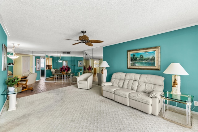 living room featuring a textured ceiling, carpet floors, and ceiling fan