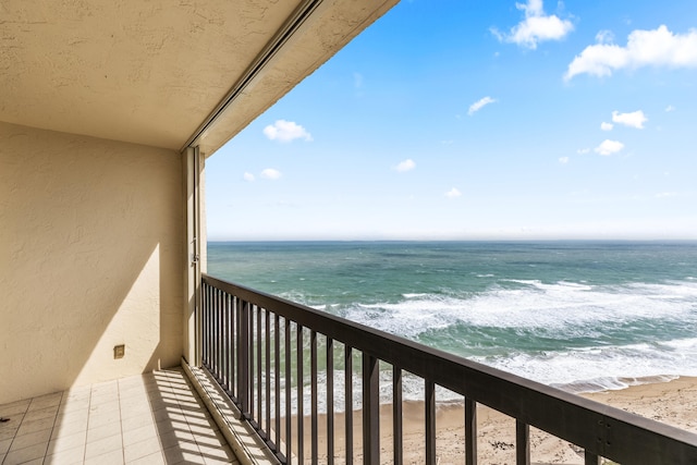 balcony with a view of the beach and a water view