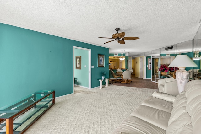 living room with ceiling fan, a textured ceiling, and carpet floors