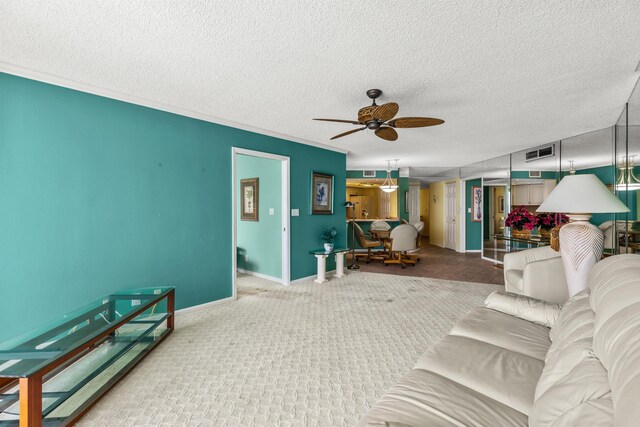 9500 S Ocean Dr Unit 1909, Jensen Beach, FL 34957 - carpeted living area with a ceiling fan, a textured ceiling, baseboards, and crown molding