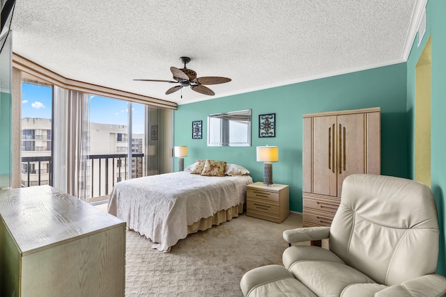 carpeted bedroom featuring ornamental molding, a textured ceiling, access to outside, and ceiling fan